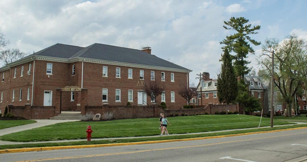 Students walking in front of Lamada Chi Alpha fraternity house on Tallawanda Road.