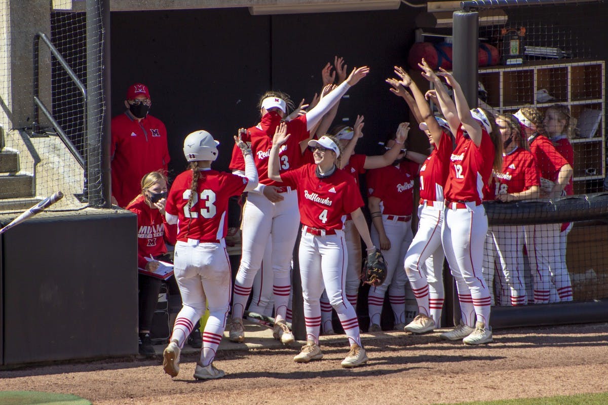 The bench celebrates after junior infielder Allie Cummins scores a run.
