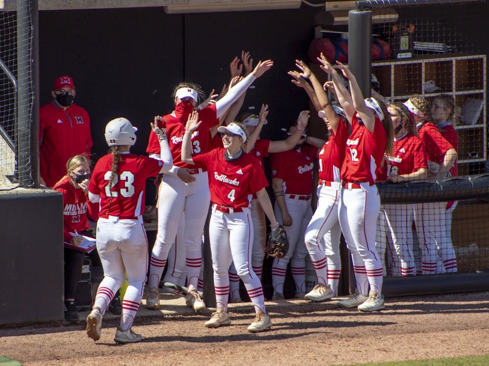 The bench celebrates after junior infielder Allie Cummins scores a run.