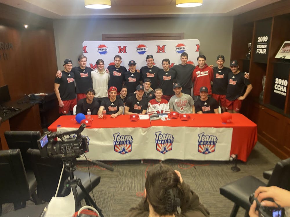 Liam Jergenson signs his national letter of intent to become a Miami RedHawk with all of his new RedHawks teammates