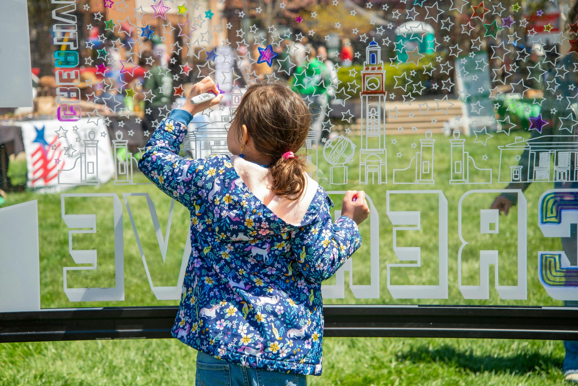 A young girl colors in a star. Photo by Caitlin Dominski