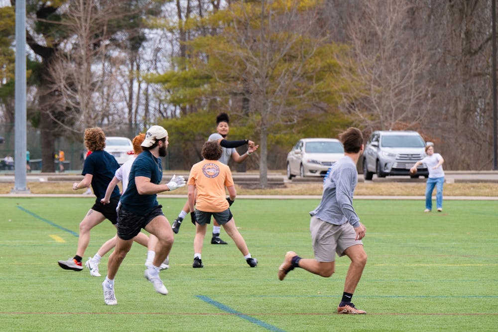 <p>Students play football in the warm weather on Feb. 26. Cook Field is home to a variety of intramural sports. </p>