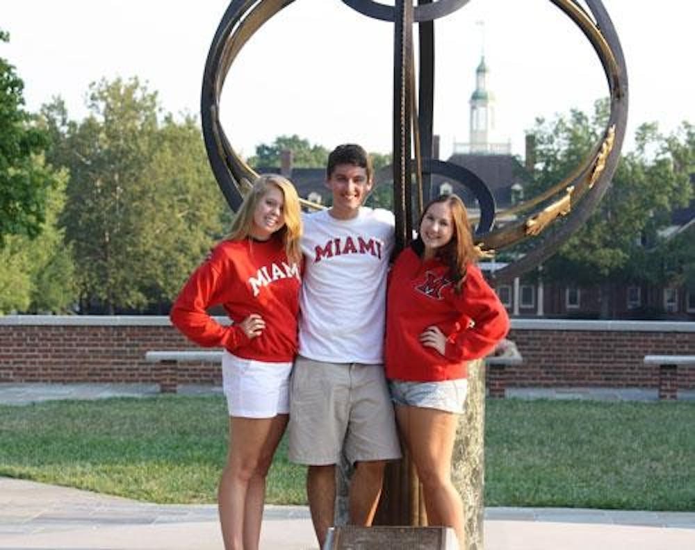 Aimee Venott, Dominic Competti and Katie Knipfing display their Miami spirit in front of the Sundial.