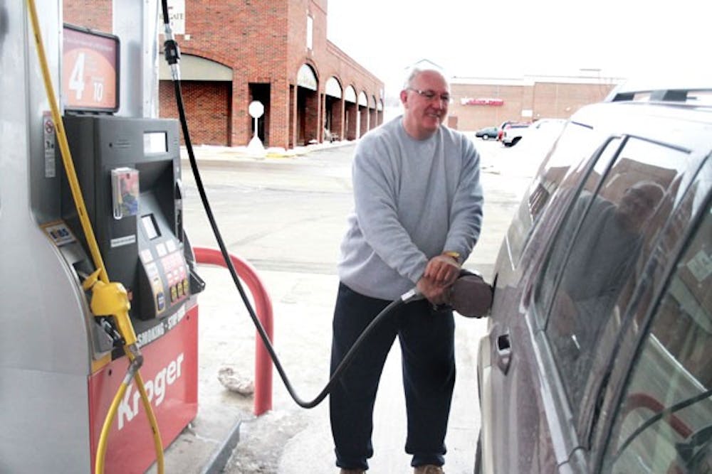 Oxford resident Kevin Wilson reaps the benefits of his Kroger Plus Card fuel perks Thursday afternoon.  Customers can now get 10 cents off per gallon at Shell stations when they earn 100 points at their local store.
