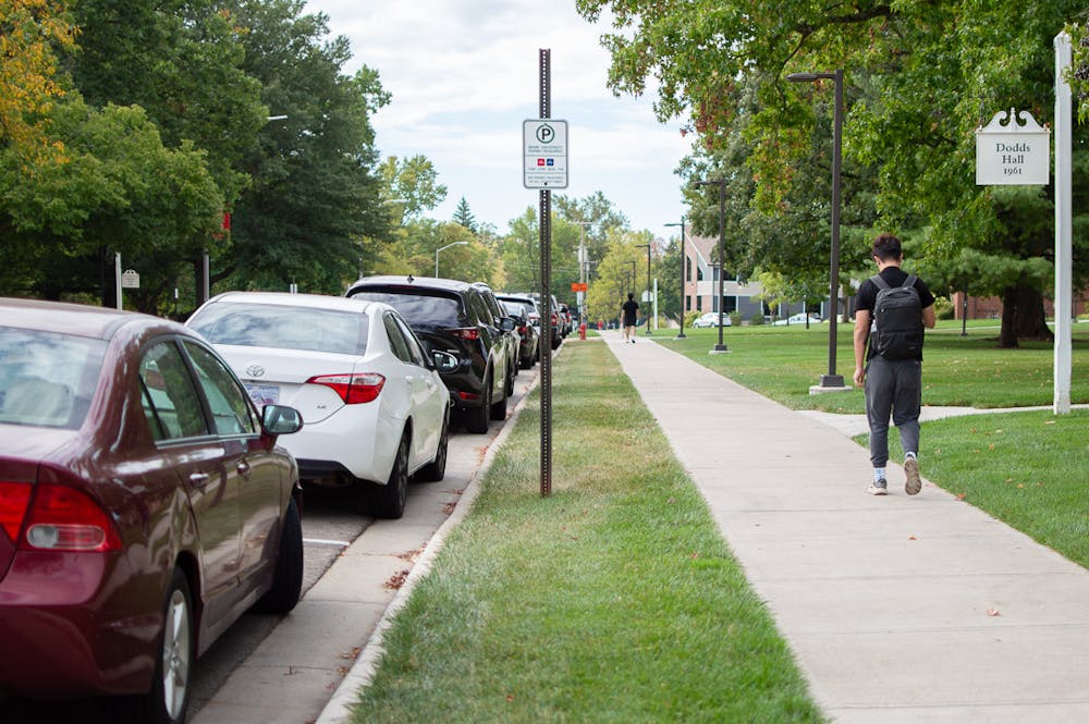 Cars line the street outside Dodds Hall, a Miami University parking permit zone. 