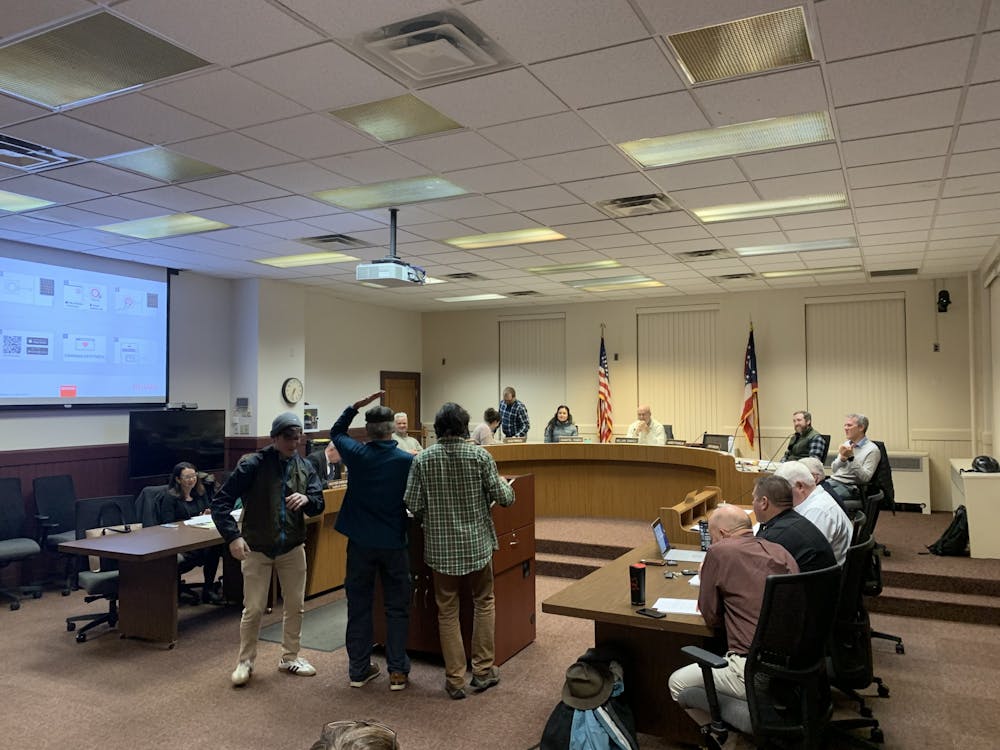 Oxford City Council's Dec. 6 meeting began with an entertaining presentation as members of the Oxford Farmers Market sang a parody of Queen's "We Will Rock You," called "We Will Feed You." Another member gave audience members apples as they performed.