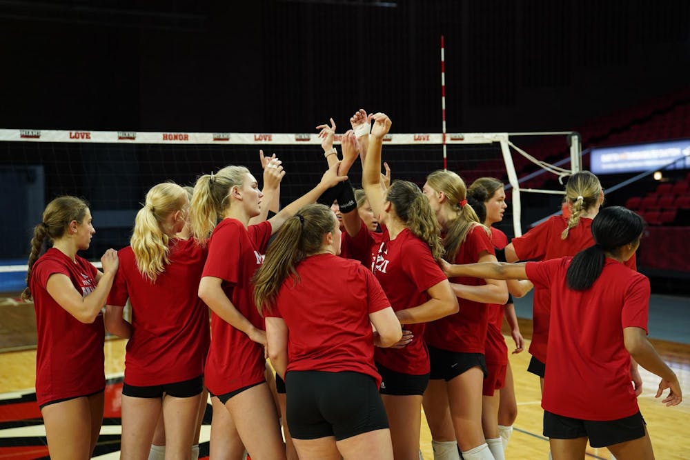 The Miami RedHawks volleyball team celebrates at the end of practice.