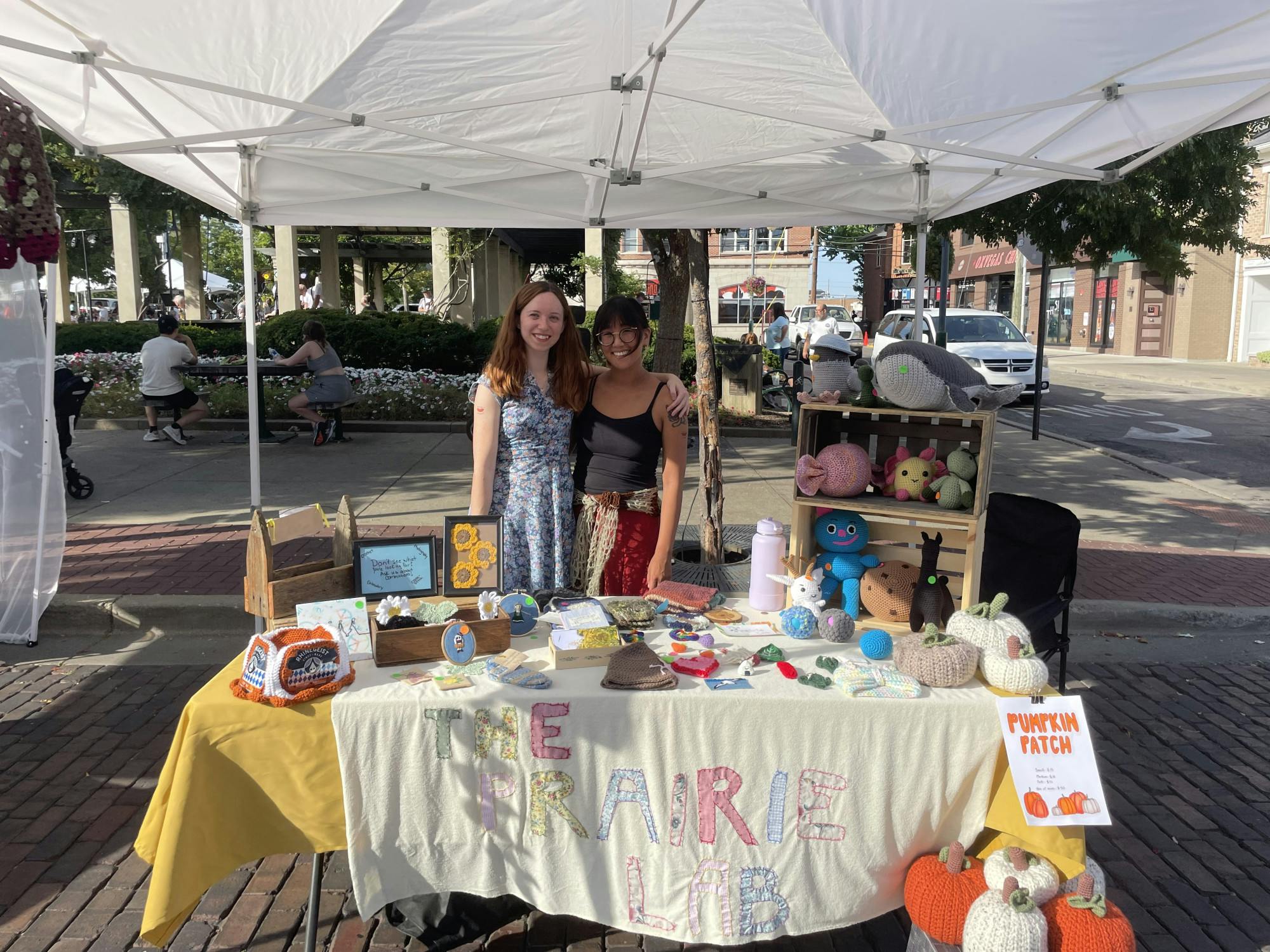 Grace Brock (left) is part of the Prairie Lab, a local business in Oxford. The team sets up their booth at Oxtoberfest.