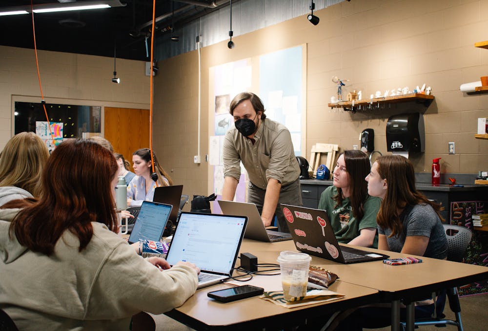 Dr. Luke Meekan assists his students with creating lesson plans during ART 295, “Elementary Art Methods.”