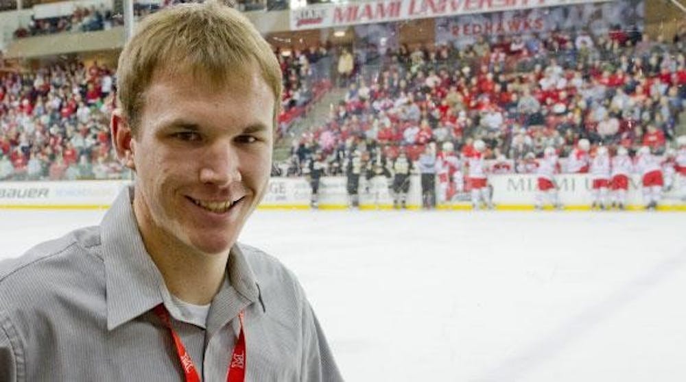Senior Ryan Mortensen, an athletic intern, works with Miami hockey.