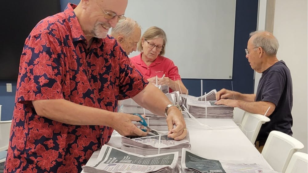 Mayor Bill Snavely volunteers to distribute Oxford Free Press papers one Friday morning.