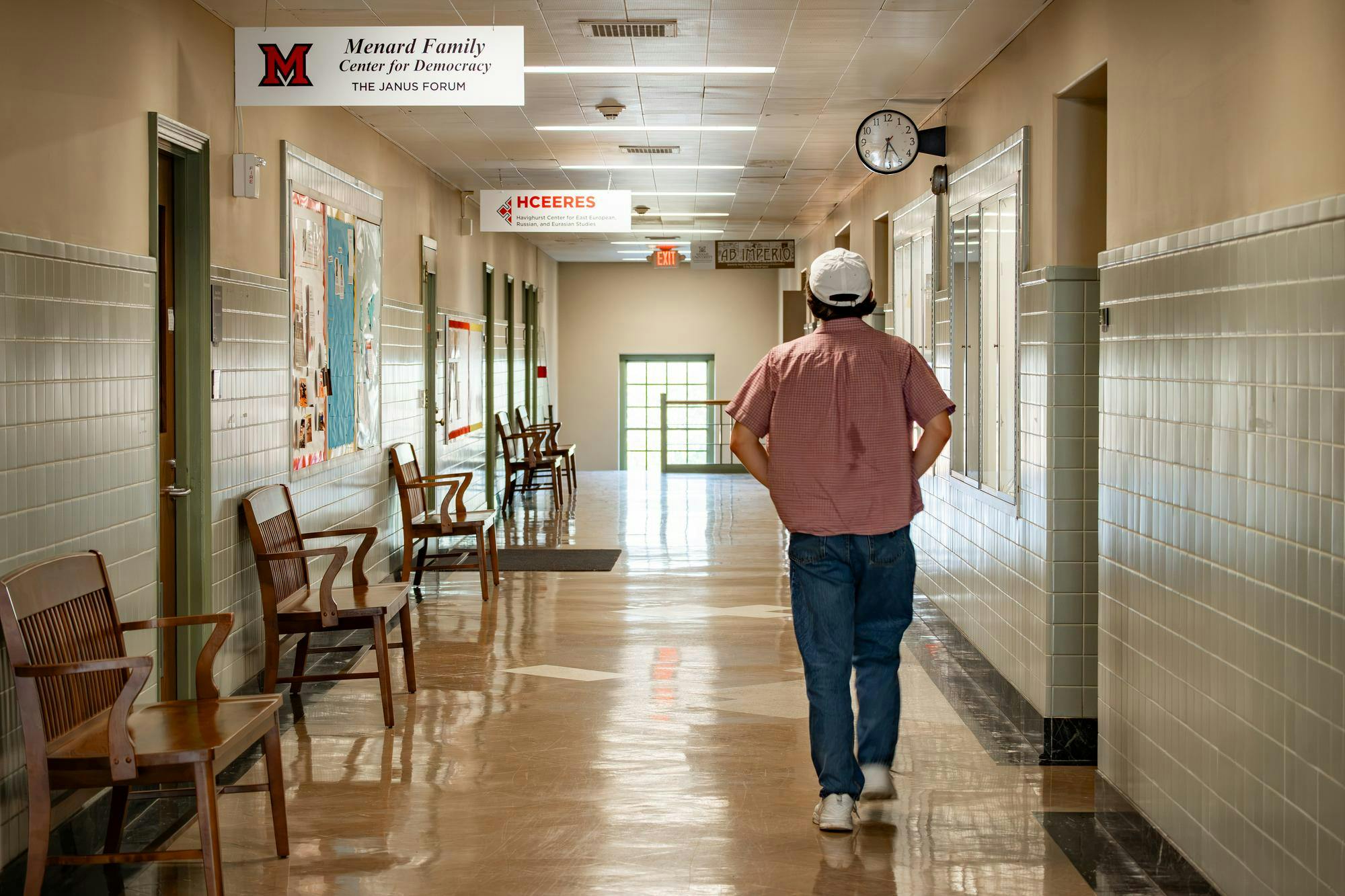 A student walks past the Menard Family Center for Democracy located in Harrison Hall.