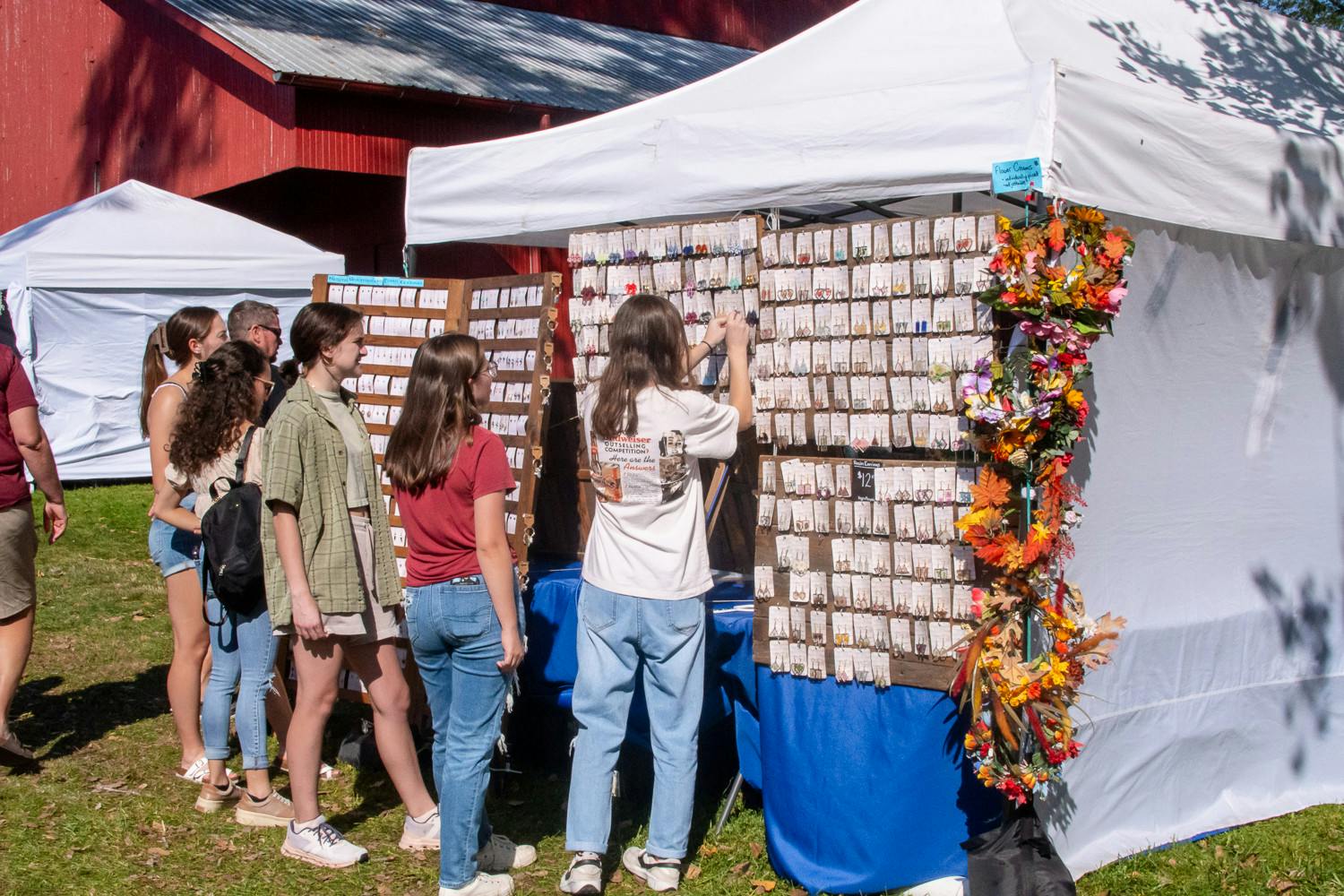 Visitors to the festival explore the large jewelry selection.