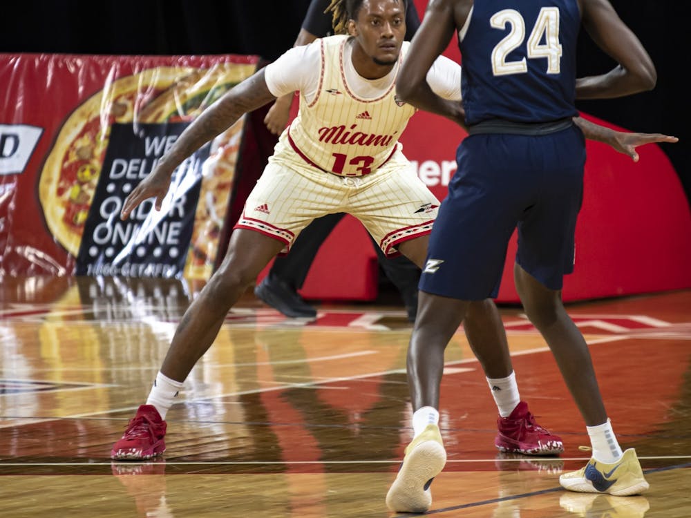 Senior forward Dalonte Brown (pictured, no. 13) gets down in a defensive stance during a loss to Akron.