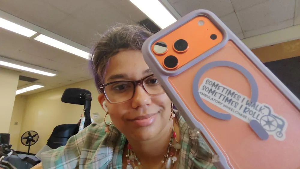 Whitney Wilson-Harris has a sticker on the back of her phone that reads, “Sometimes I walk, Sometimes I roll. Ambulatory Wheelchair User.” Photo provided by Whitney Wilson-Harris