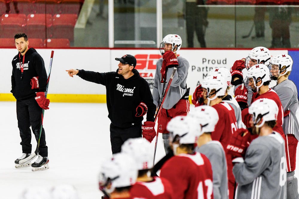 <p>Miami hockey assistant coach Troy Thibodeau conducts a drill at practice on September 26</p>