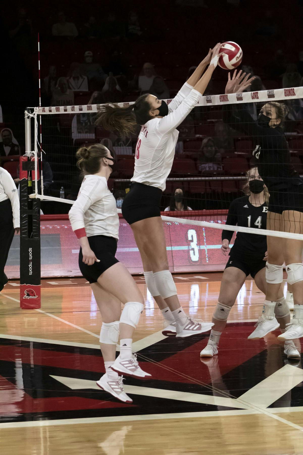 Senior right side Avarie Powell (pictured, middle) gets a block during a weekend series vs. Eastern Michigan.