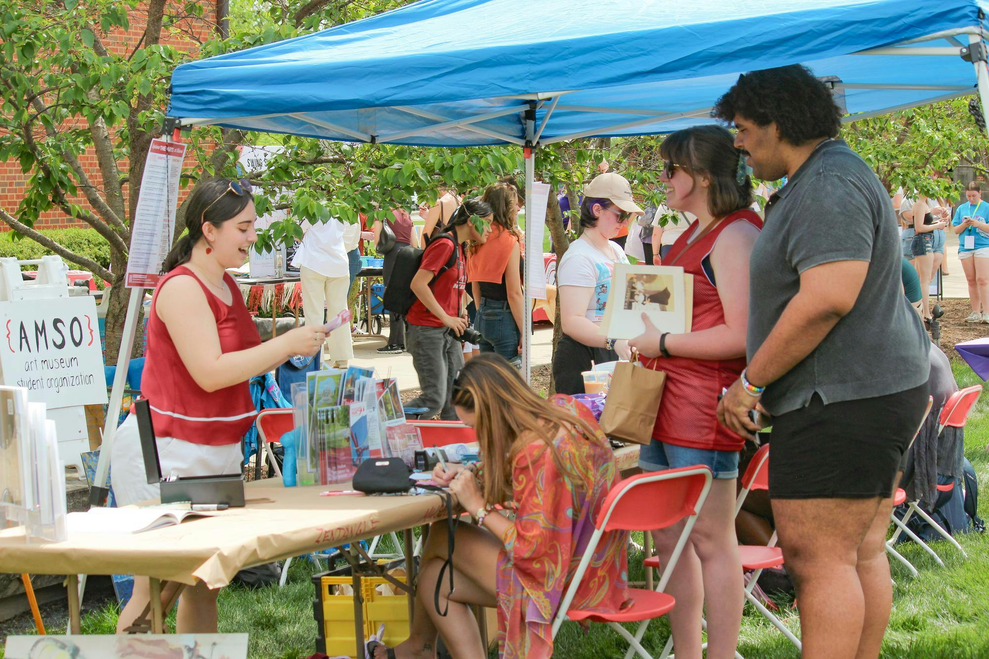 People stop at the Art Museum Student organization booth at Sparkfest.