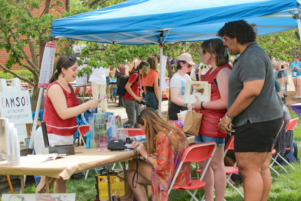 People stop at the Art Museum Student organization booth at Sparkfest.