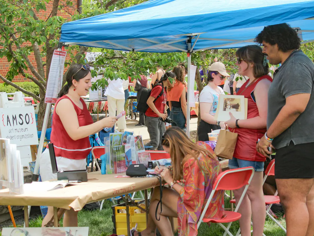 People stop at the Art Museum Student organization booth at Sparkfest.