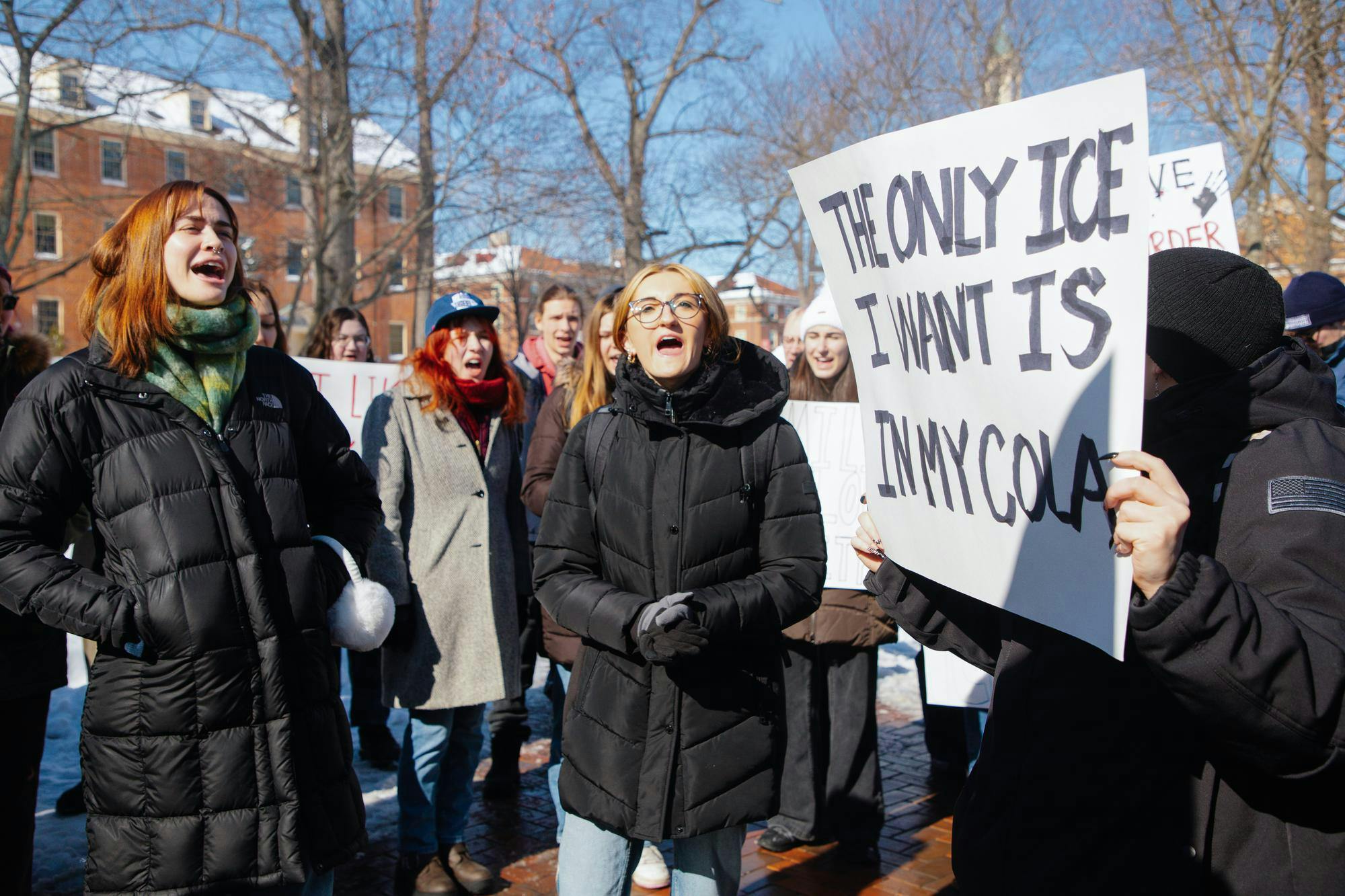 Students protest ICE with posters at the Seal