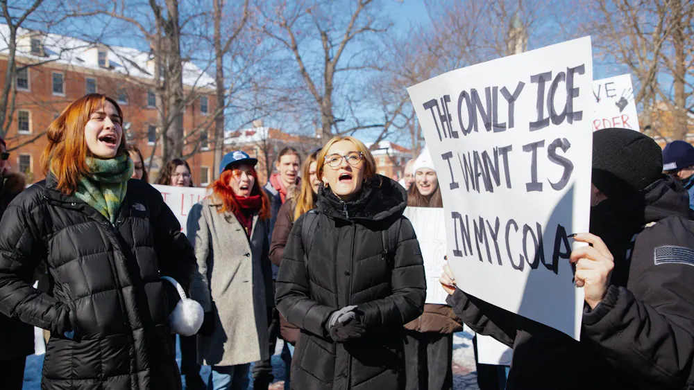 Students protest ICE with posters at the Seal