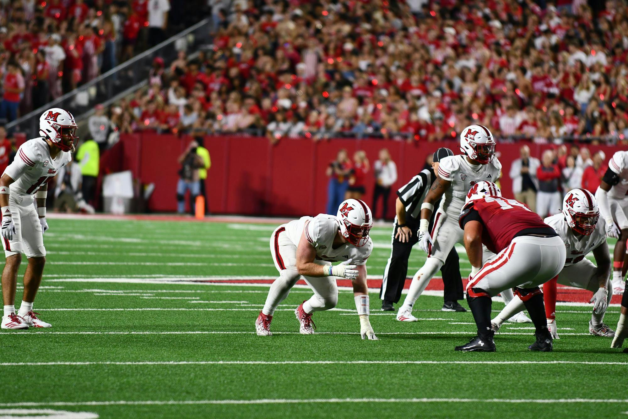 Miami’s defensive line prepares for a Wisconsin snap at Camp Randall Stadium during the first game of the season on Aug. 28.
