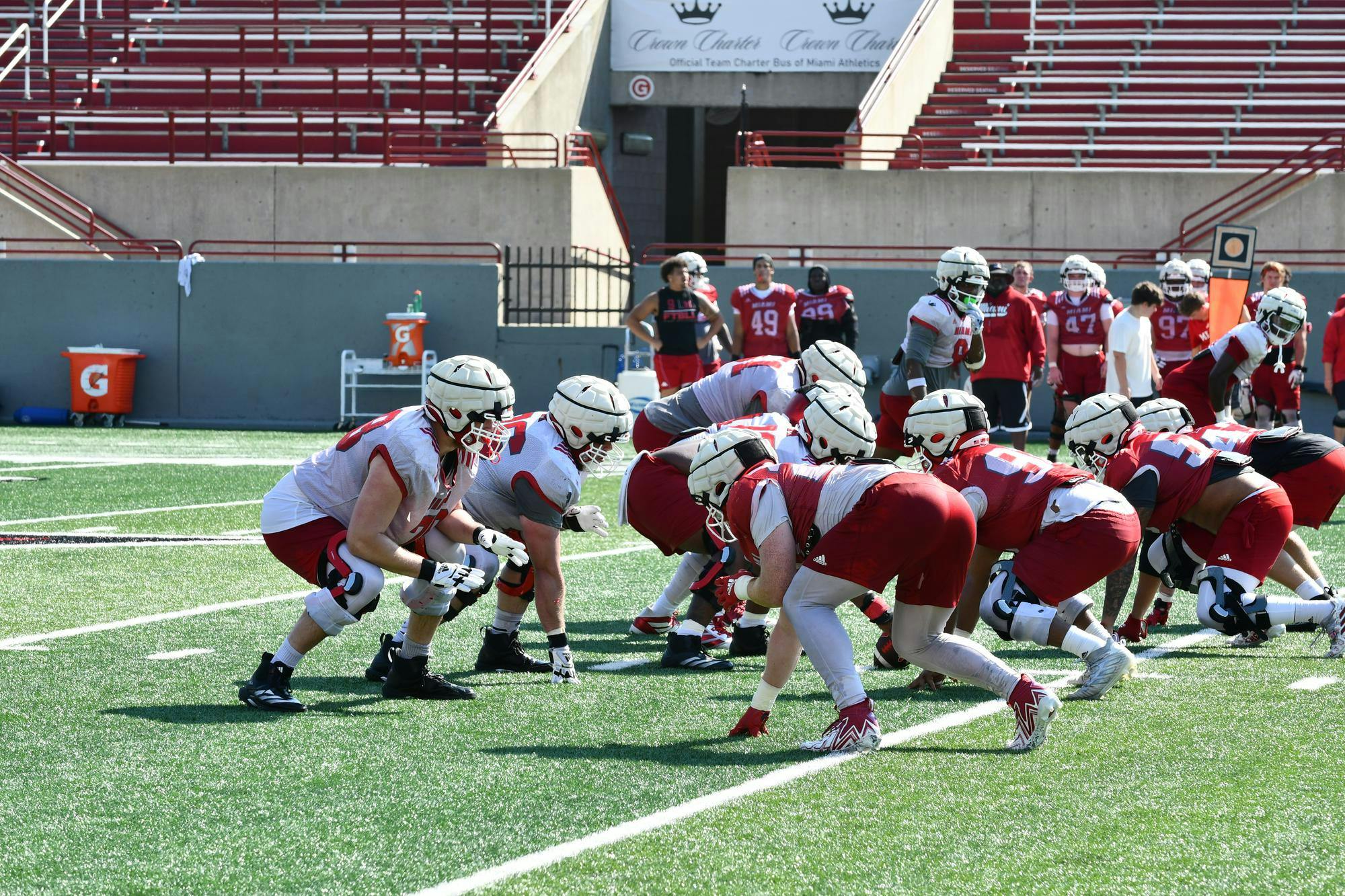 The Miami football team lines up for a snap at practice on Aug. 7.