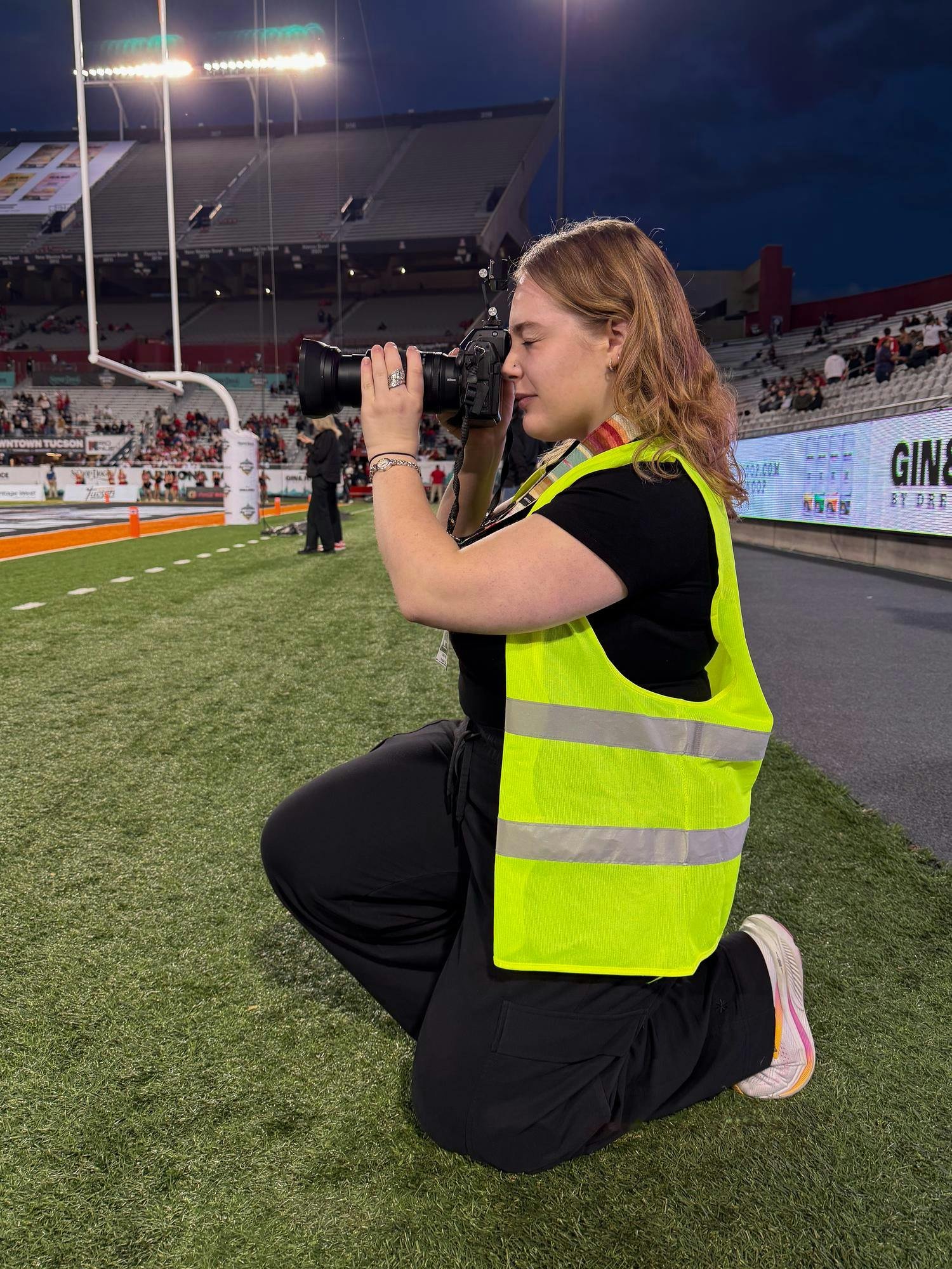 Sarah Frosch photographs the 2025 Snoop Dogg Arizona Bowl game in Tucson, Arizona.