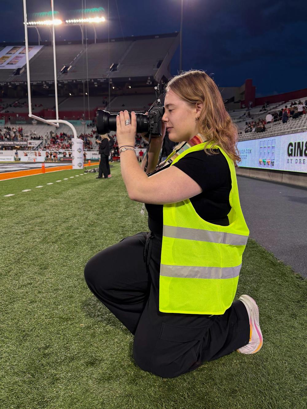 Sarah Frosch photographs the 2025 Snoop Dogg Arizona Bowl game in Tucson, Arizona.