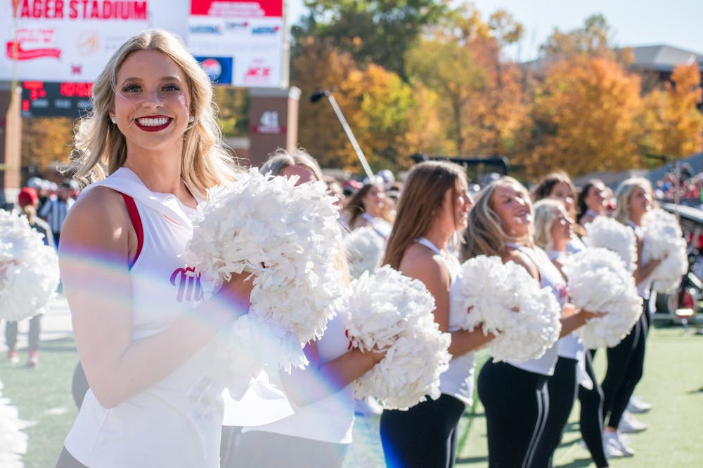 The Miami University Dance Team cheering with the crowd against Central Michigan University.