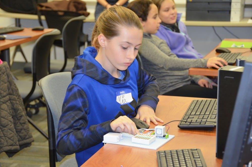 A student participates in Kode2Learn Day with the club. 