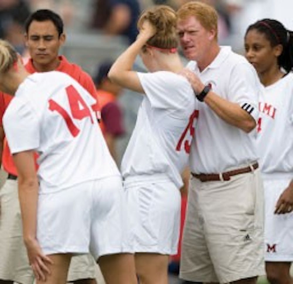 Soccer Head Coach Bobby Kramig advises junior Haley Clark during a game last season v. Western Michigan University.