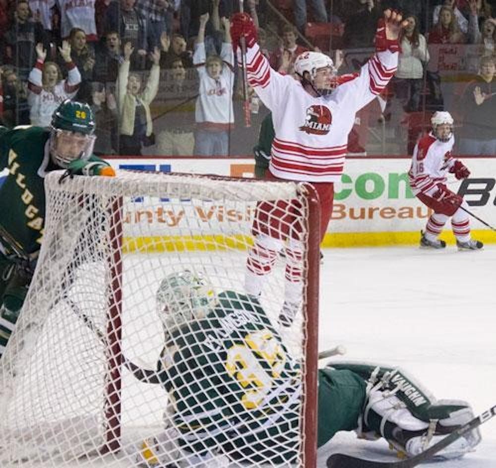 Freshman forward Tyler Biggs celebrates Miami University’s sixth goal during their shutout win Saturday night against  Northern Michigan University. The win keeps the ’Hawks tied for second place in the Central Collegiate Hockey Association.