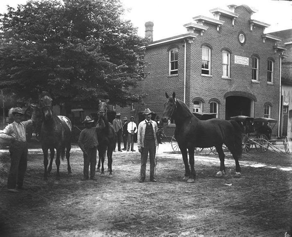<p>Ezra Bourne and his staff posing with the horses they care for. ﻿</p>