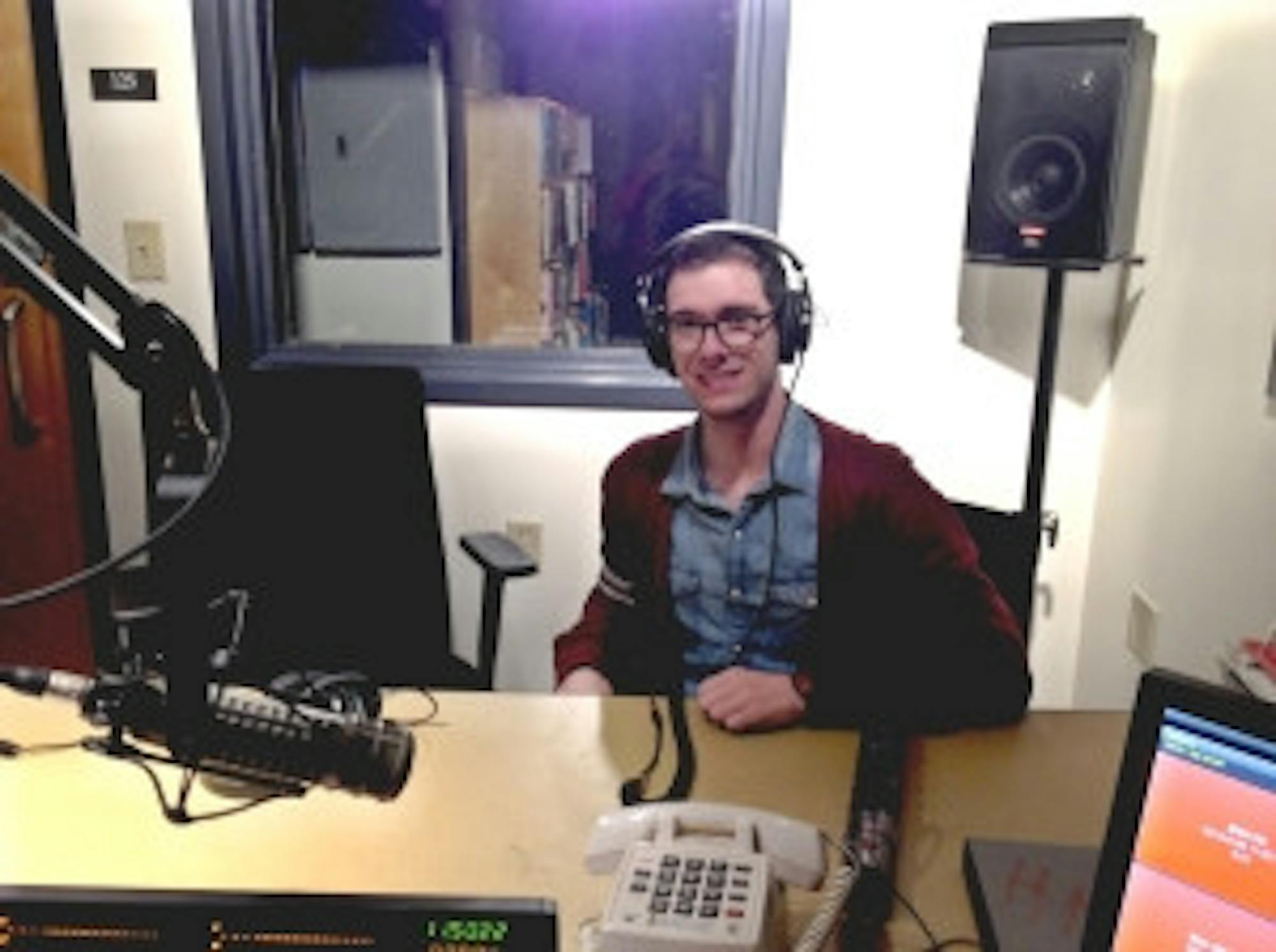 Abbi Sleeper/staff Student DJ Harry Wolfson, sits at his desk in the WUNH studio. This is his third year at WUNH.