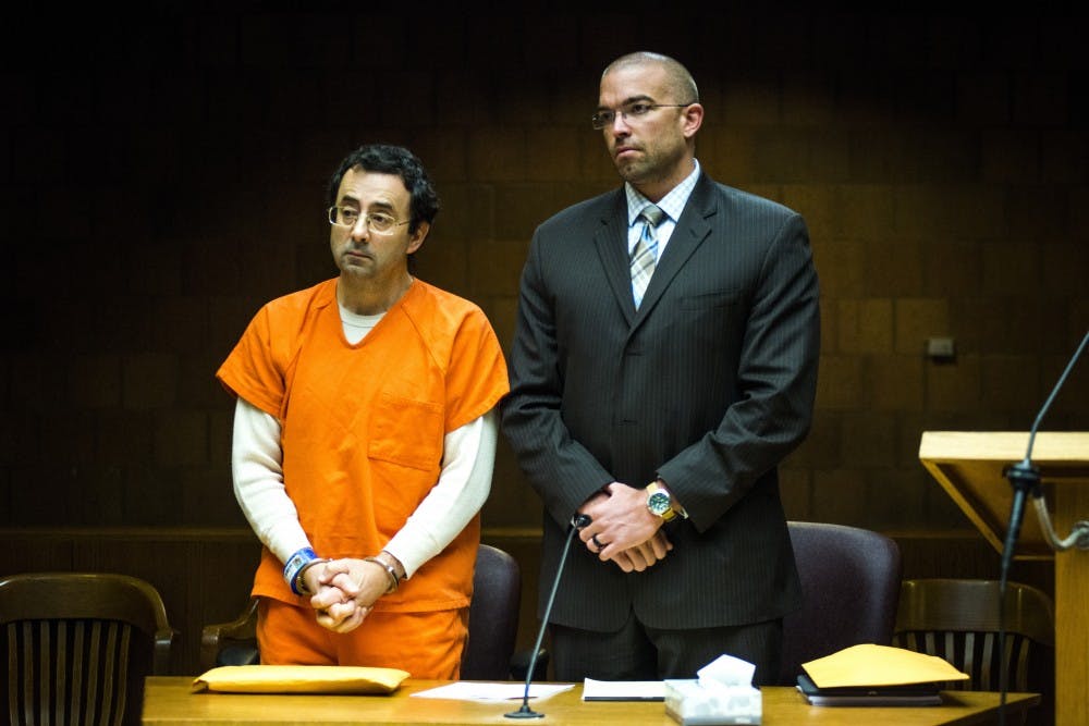 Former MSU employee Larry Nassar, left, appears alongside his defense attorney, Matt Newburg, during a preliminary examination conference on March 2, 2017 at 55th District Court in Mason, Mich. Nassar's preliminary examination was deferred to May 12, 2017.