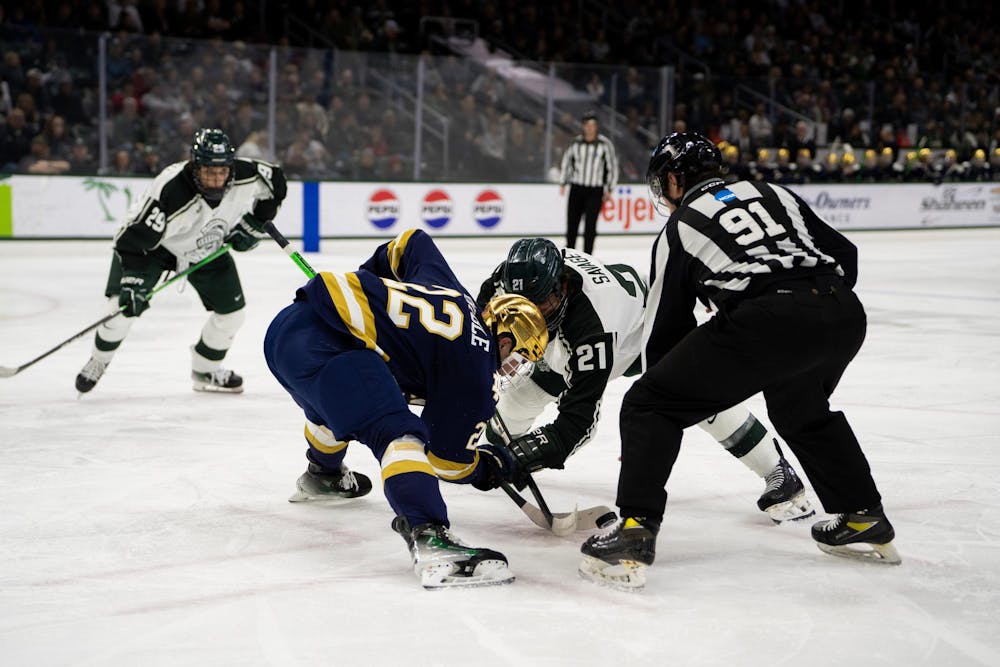 <p>Michigan State Junior Forward Red Savage (21) battles Notre Dame Freshman Forward Cole Knuble during their game at Munn Arena in East Lansing on Dec. 8, 2023. Michigan State won the first of two games against the visiting Notre Dame squad 5-2.</p>