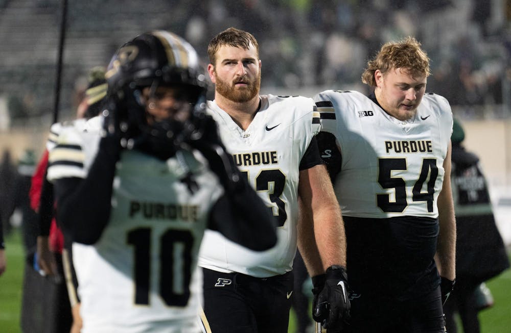 <p>Purdue senior offensive lineman Gus Hartwig (53) and senior offensive lineman Luke Griffin (54) walk off the field after the team's loss against Michigan State at Spartan Stadium on Nov. 22, 2024.</p>