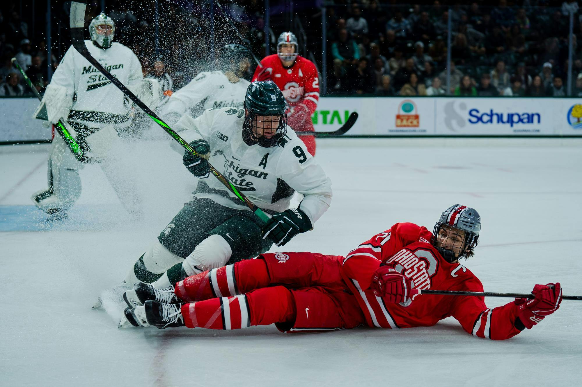 <p>Michigan State junior defenseman Matt Basgall (9) cuts off Ohio State graduate forward Patrick Guzzo (71) at Munn Ice Arena on Nov. 9, 2024. Michigan State takes the win with 4-1.</p>