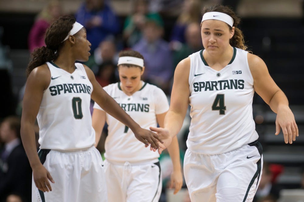 	<p>Junior center Jasmine Hines high fives junior guard Kiana Johnson towards the end of the game against Penn State on Jan. 19, 2014, at Breslin Center. The Spartans lost, 66-54. Julia Nagy/The State News </p>