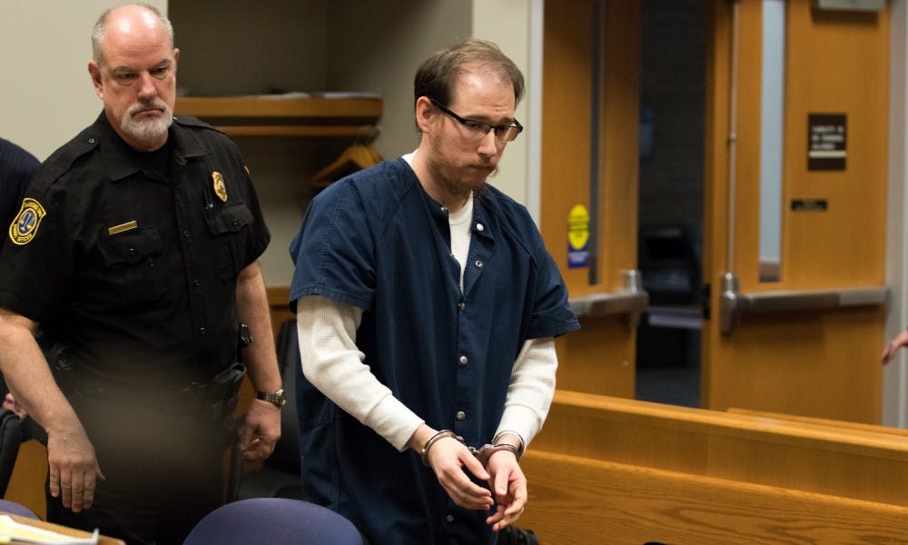 <p>Michael Phinn, an MSU medical resident, walks out of the court on a recess during a preliminary hearing at 54B District Court on Jan. 15, 2019. Phinn faces 14 charges relating to sexual assault including one count of first-degree criminal sexual conduct.</p>