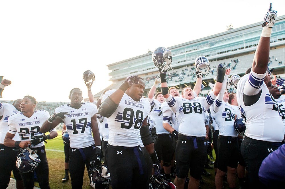 	<p>The Northwestern Wildcats celebrate after defeating the Spartans on Saturday, Nov. 17, 2012, at Spartan Stadium. The Spartans&#8217; fell 23-20 to the Wildcats. James Ristau/The State News</p>