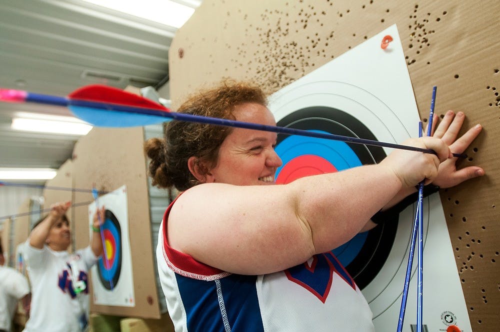 	<p>San Francisco resident Lucy Williams pulls out an arrow Aug. 7, 2013, during the World Dwarf Games at Demmer Shooting Sports, Education and Training Center. Williams scored 17 points over 10 rounds of shooting. Weston Brooks/The State News  </p>