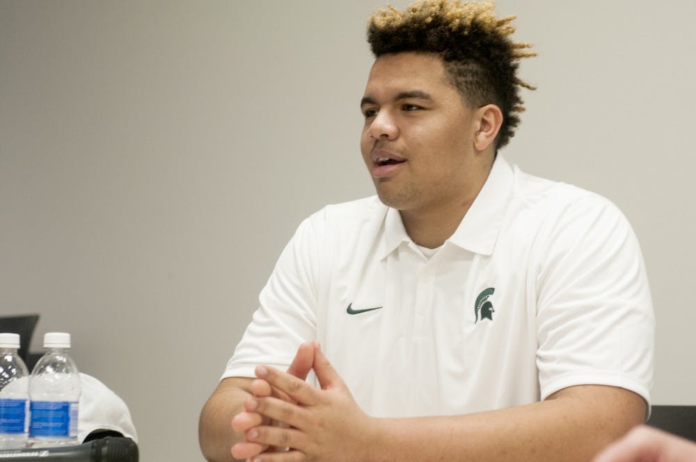 Freshman offensive tackle Thiyo Lukusa speaks to members of the media during a round table press conference on Jan. 15, 2016 at Spartan Stadium. After Coach Mark Dantonio addressed the press, seven of the eight early enrollees discussed their excitement for joining the program and their adjustment to college life. 
