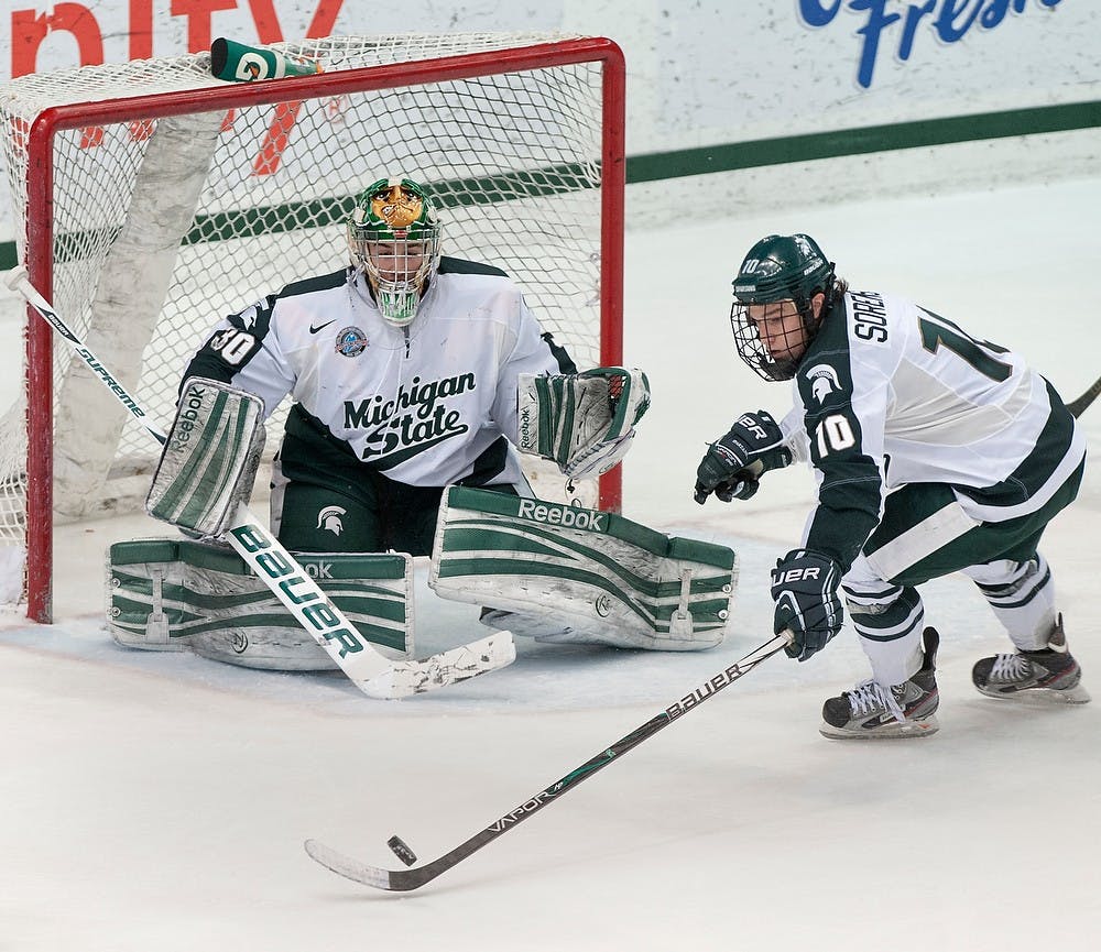 	<p>Sophomore forward Tanner Sorenson blocks a shot by Northern Michigan in front of freshman goaltender Jake Hildebrand. The Spartans defeated the Wildcats, 4-2, Saturday, Feb. 16, 2013, at Munn Ice Arena. Justin Wan/The State News</p>
