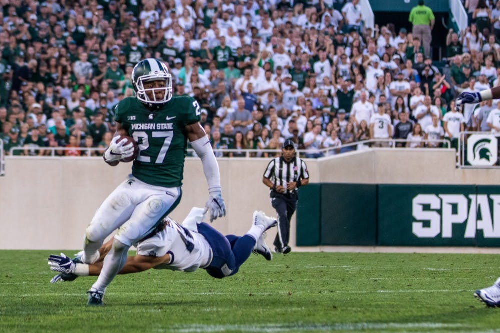 Senior safety Khari Willis (27) returns an interception during the game against Utah State on Aug. 31 at Spartan Stadium. The Spartans led the Aggies, 20-14 at the half.