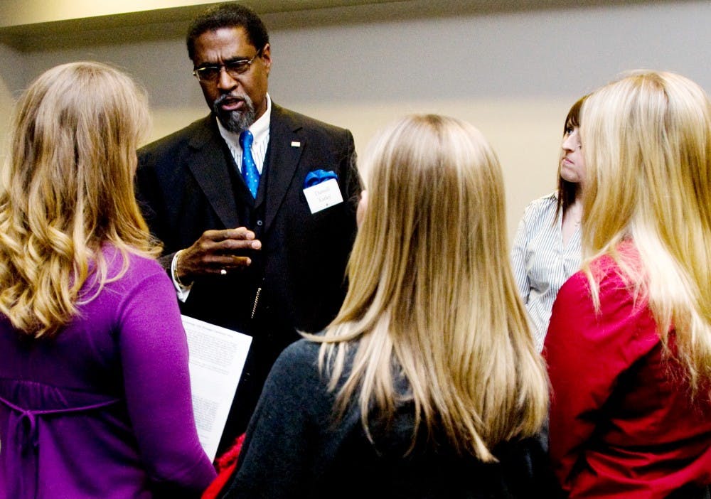 City Manager for the city of Saginaw Darnell Earley talks with a group of MSU students and community members who attended the community reception Wednesday night at Hannah Community Center, 819 Abbot Road. Aaron Snyder/The State News  