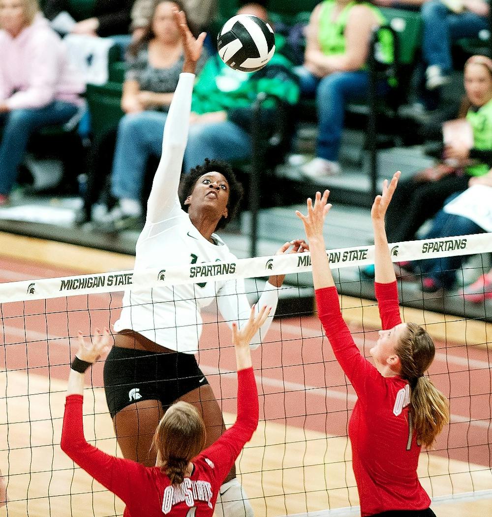 Junior middle blocker Alexis Mathews spikes the ball during the women's volleyball game against Ohio State on Saturday at the Jenison Field House. MSU lost the game 3-1 and is due to play Indiana on Oct. 26. Danyelle Morrow/The State News