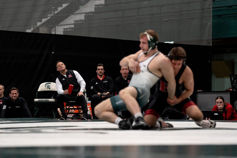 <p>Rutgers coaching staff watch as Michigan State No. 11 senior Caleb Fish (17-4) faces No. 86 junior Anthony White (9-8) of Rutgers. Michigan State fell to No. 12 Rutgers 22-13, falling to 0-2 in conference play.</p>